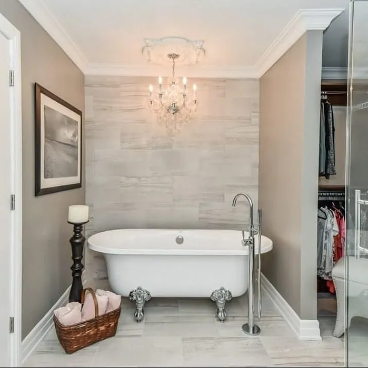 Classic clawfoot tub with crystal chandelier in ensuite renovation in Galt by Caliber Contracting
