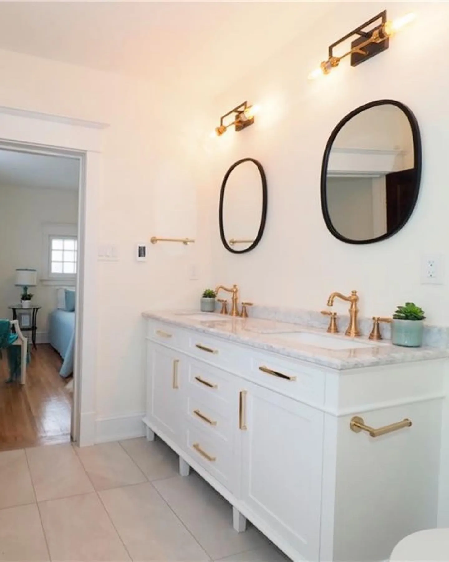 Ensuite with double vanity and gold accents in Kitchener by Caliber Contracting