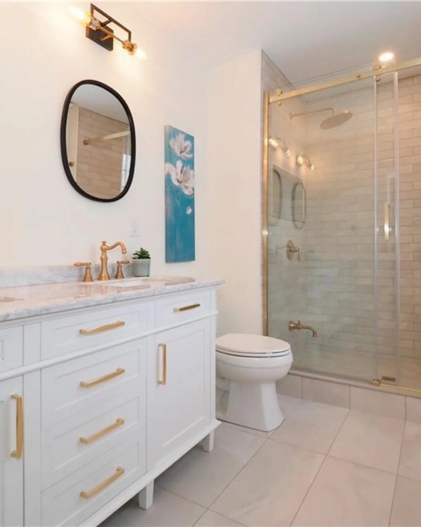 Ensuite with large shower and gold accents in Kitchener by Caliber Contracting