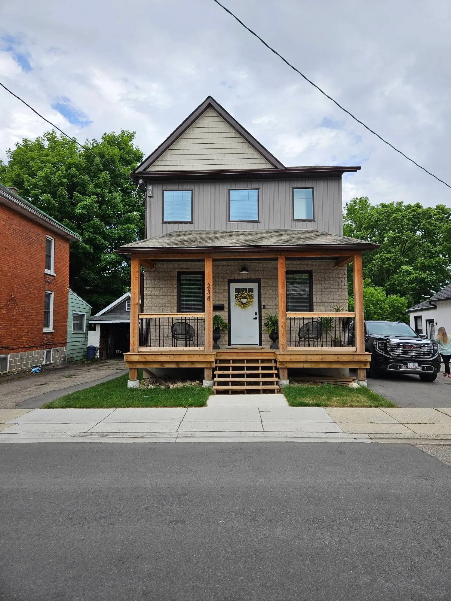 New custom home build with covered porch in Cambridge by Caliber Contracting