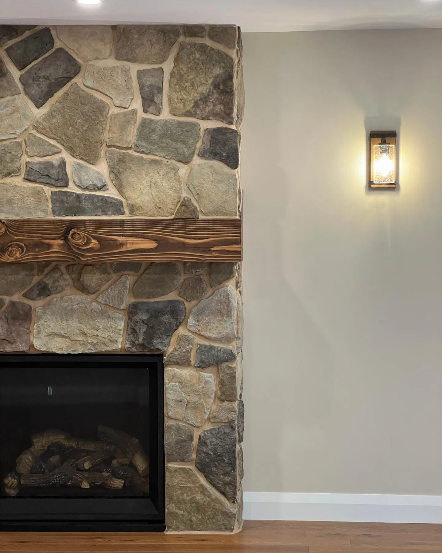 New gas fireplace with stone surround in Waterloo by Caliber Contracting