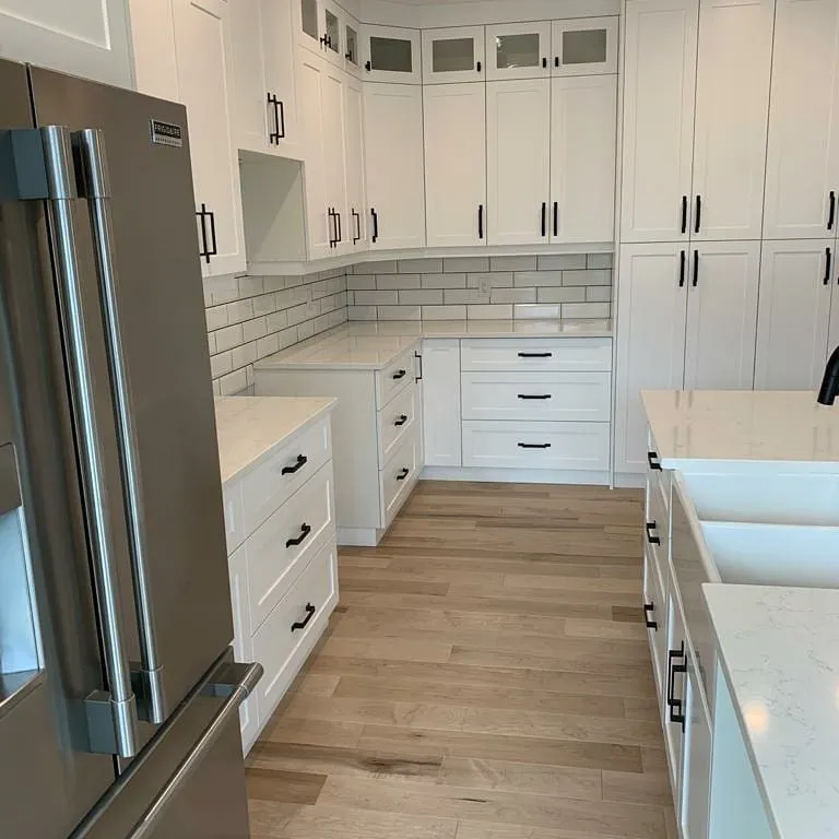 White farmhouse kitchen in Waterloo by Caliber Contracting