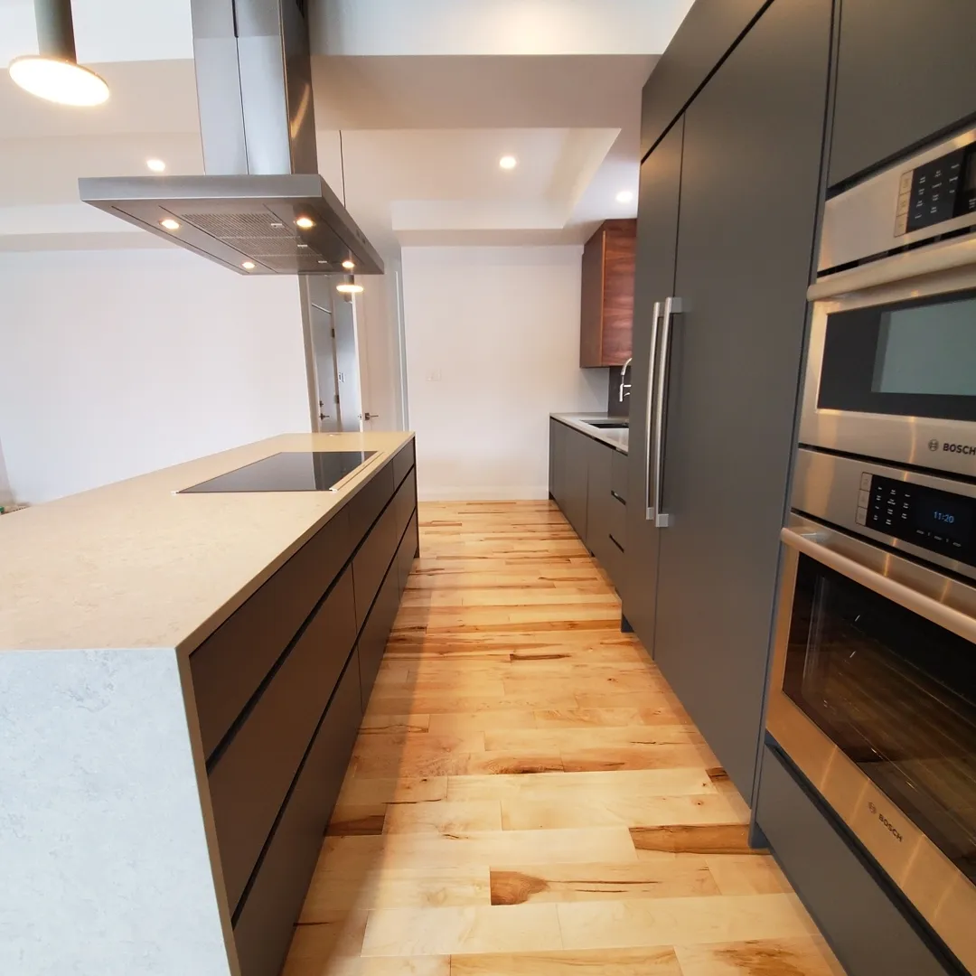 Ultra modern flat panel kitchen with walnut accents in Kitchener by Caliber Contracting