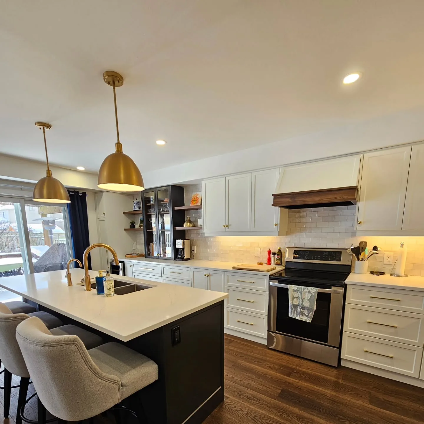 Open-concept custom kitchen with navy island in Kiwanis Park, Kitchener