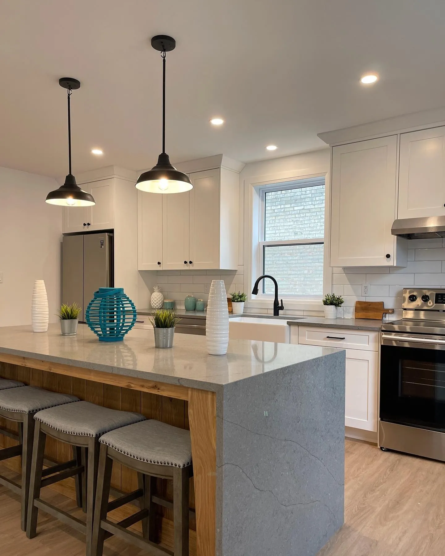 White oak kitchen with waterfall countertops in Cambridge by Caliber Contracting