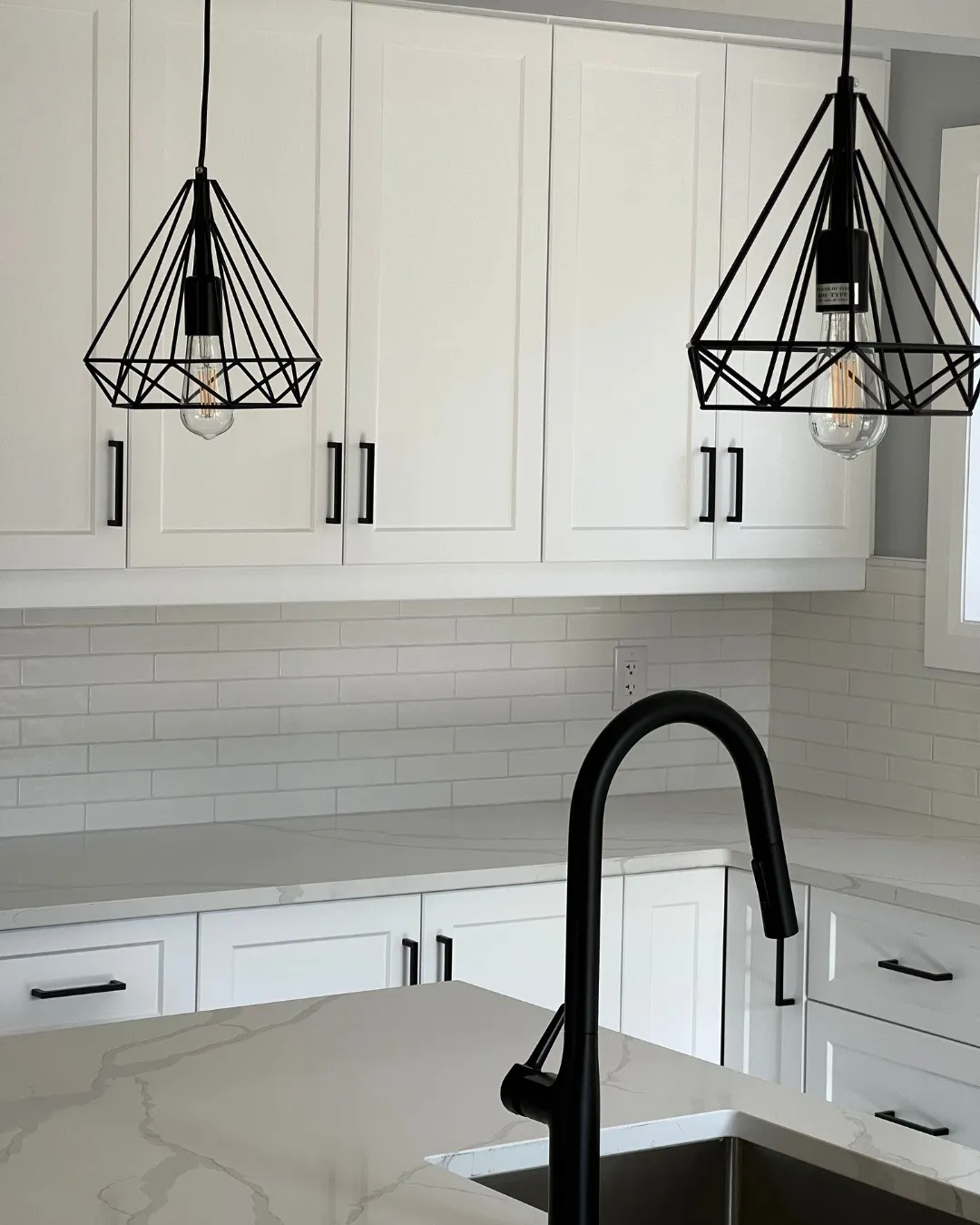 White cabinets with black accents in Ayr by Caliber Contracting